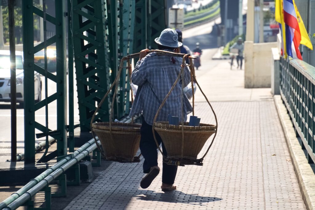 A person carrying baskets on their back